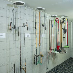 Fishing rods and tools on wall mounts